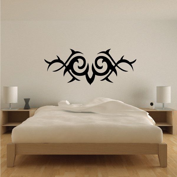 Tribal wall decal with black swirling ornamental design, centered on wall