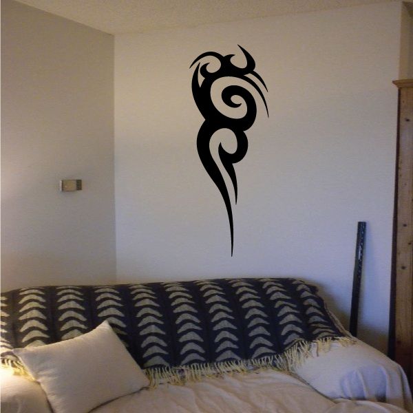 Tribal vinyl wall decal with black swirling tribal figure above a bed
