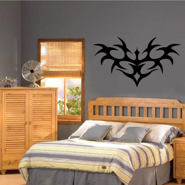 Black tribal vine wall decal with swirling leaf shapes