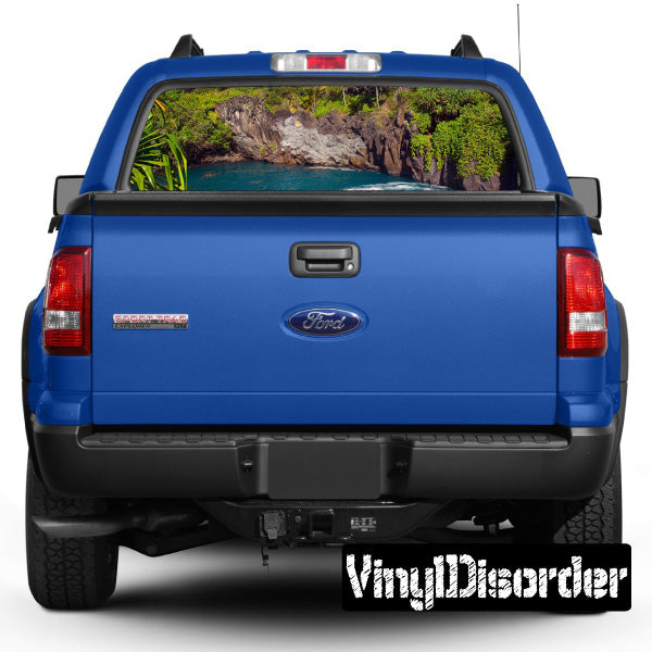 Blue pickup truck rear with landscape graphic through rear window