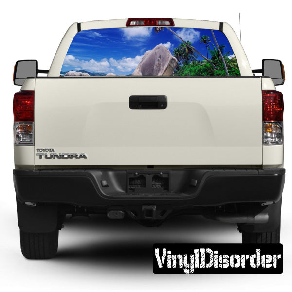 Vehicle rear window graphic with tropical beach and palm tree scene