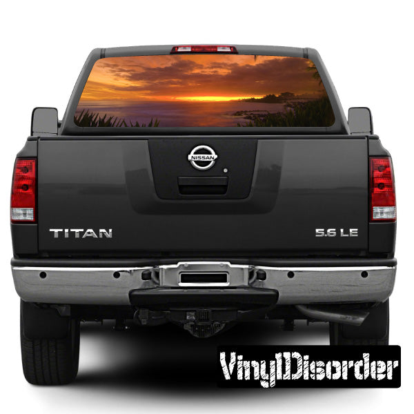 Tropical rear window view graphic on pickup truck rear window, sunset and ocean