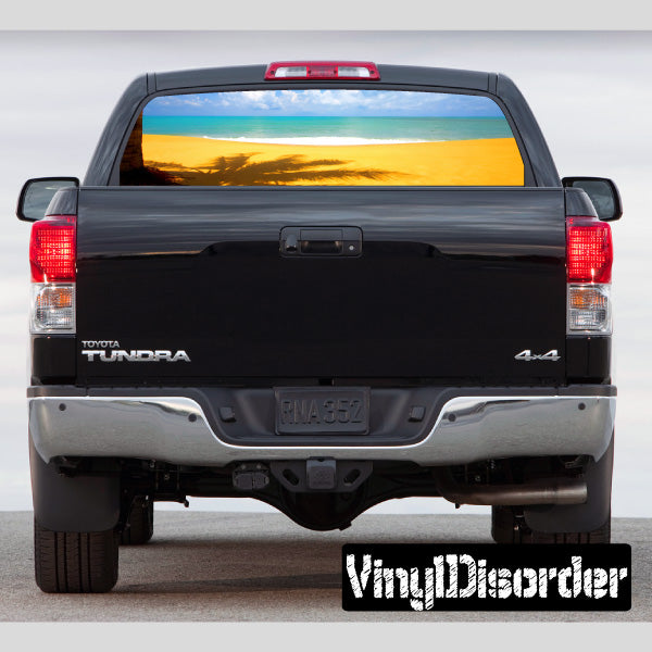 Rear window graphic decal showing tropical beach landscape through pickup window
