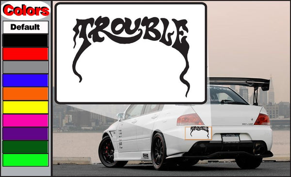Trouble decal on white background with black stylized lettering, rectangular shape