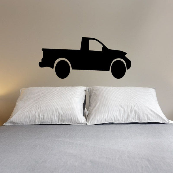 Black truck vinyl wall decal silhouette on wall above bed pillows