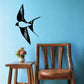 Turning mid-flight bird decal with wings spread, black silhouette