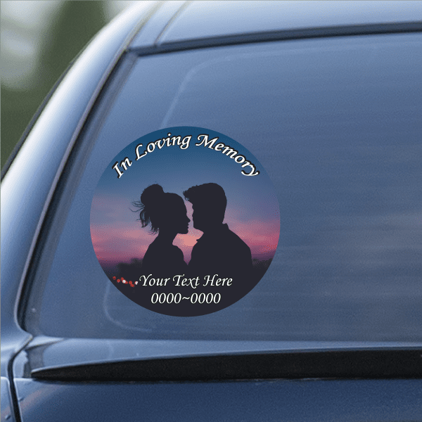 Round car window sticker with couple silhouettes and text 'In Loving Memory'.