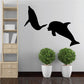 Two dolphins swimming decal with black silhouette of two dolphins in mid-swim
