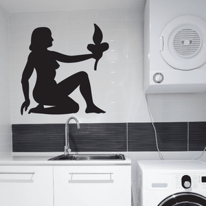 Seated silhouette figure wall decal, holding a small flame-like shape.