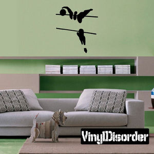 Volleyball wall decal of black player silhouettes on a wall