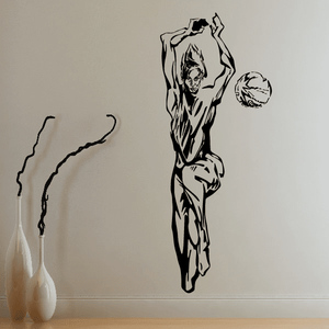 Volleyball wall decal of a black player silhouette with a raised arm holding a ball