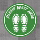 Green non-slip circular floor sticker: PLEASE WAIT HERE with shoe prints