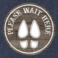 Round non-slip floor sticker reading 'Please Wait Here' with boot icon
