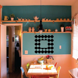 Geometric vinyl wall decal with black diamond pattern and central square