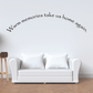 Wall decal with cursive text "Warm memories take us home again" on wall