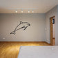 Dolphin wall decal in black line art, curved body with fins and eye