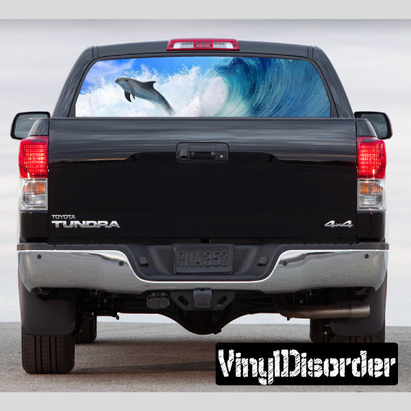 Pickup truck rear window graphic with wave and dolphin design