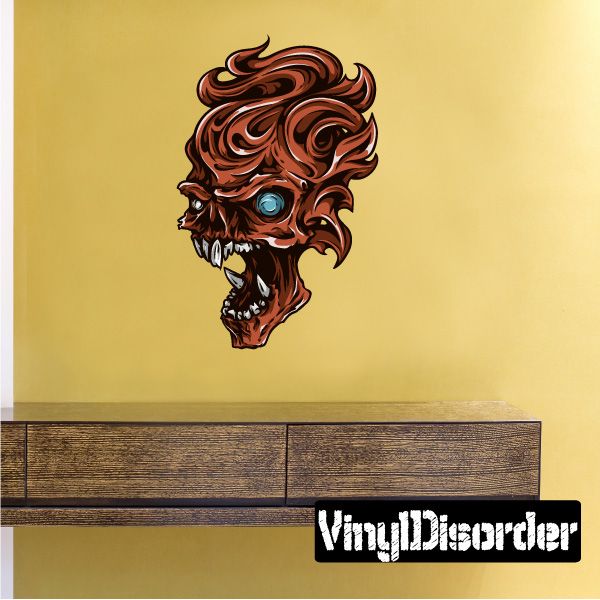Wavy skull sticker with reddish brown curls, blue eye, and toothy grinning mouth; VingDieorder
