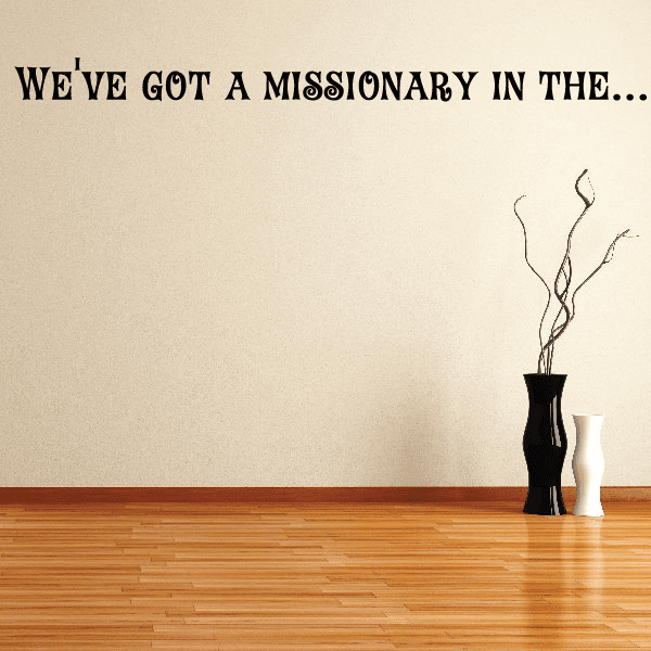 Wall decal with black text 'We've got a missionary...' and candle graphic