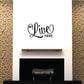 We Live Here wall decal with black cursive script and small “HERE” text