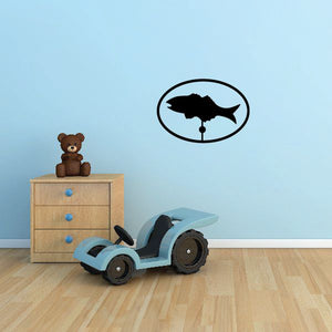 Fish weather vane decal with black fish silhouette inside an oval ring and small post
