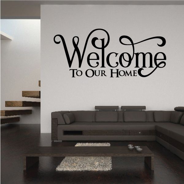 Wall decal reading “Welcome To Our Home” in black swirly script