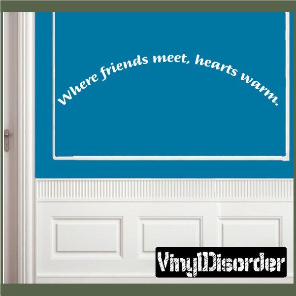 Wall decal with blue rectangle and white cursive text: "where friends meet, hearts warm!"