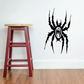 Black spider wall decal with central skull-like face and web-like legs