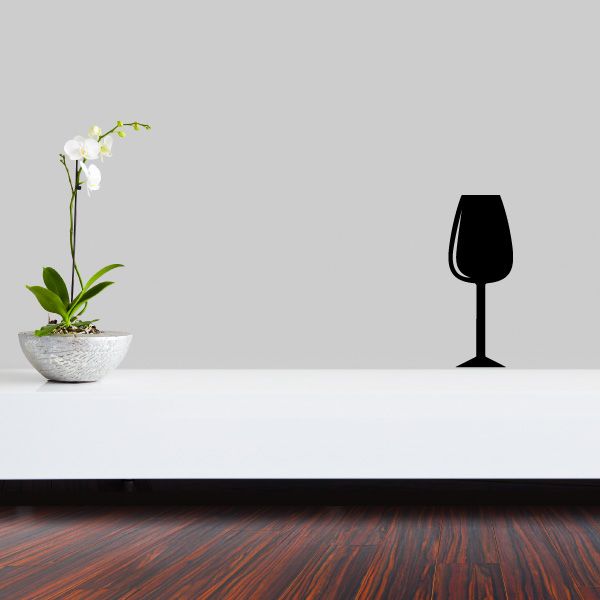 Wine glass full decal with dark silhouette on a flat surface