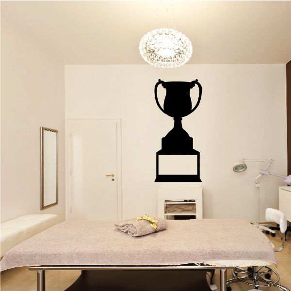 Winning trophy decal with black cup, gold base, and white nameplate.