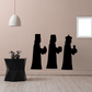 Black silhouette decal of three robed men with staffs