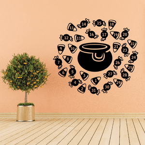 Halloween game decal with black cauldron, numbered candy corn pieces, and small bones