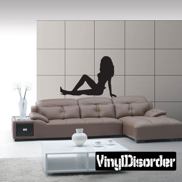Wall decal of a black silhouette woman sitting in heels on a sofa