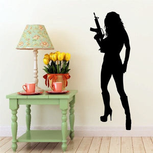 Woman in heels decal with M16 rifle silhouette, dark figure standing