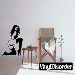 Woman silhouette decal wearing thigh-high heels, sitting with arms on knees