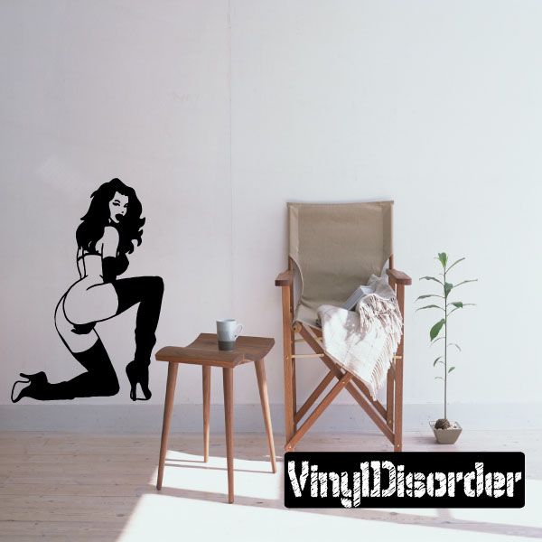 Woman silhouette decal wearing thigh-high heels, sitting with arms on knees