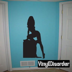 Black decal of kneeling woman silhouette sitting on a box