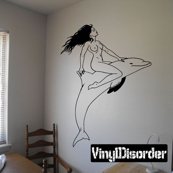 Black line art decal of a woman riding a dolphin, arched pose on wall.