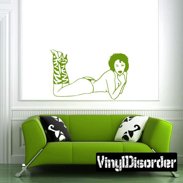 Green line-art woman wall decal wearing striped heels, reclining pose