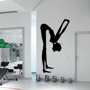 Yoga wall decal with standing figure silhouette and lifting icon in black