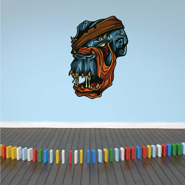 Wounded monster head sticker showing a blue and orange snarling face with wounds
