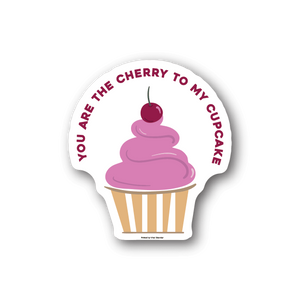 Vinyl sticker with pink cupcake and cherry topper, striped wrapper, circular text border.