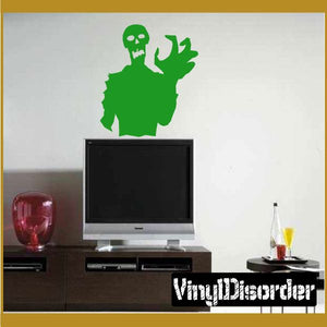 Green zombie clutch decal with raised hand and skull face on light background