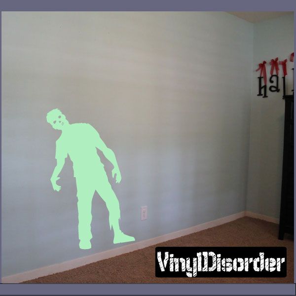 Zombie leaning decal: light green zombie figure with arms outstretched on wall.