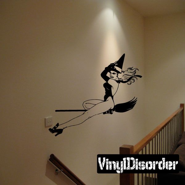 Black witch on broom wall decal, flying pose with hat and long hair