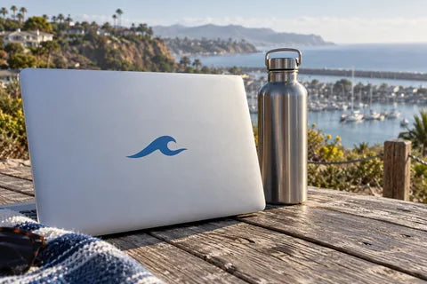 Dana Point-inspired harbor scene with a laptop and water bottle