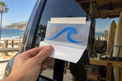 Coastal application example: a hinge holds transfer tape while the white backing liner is peeled away