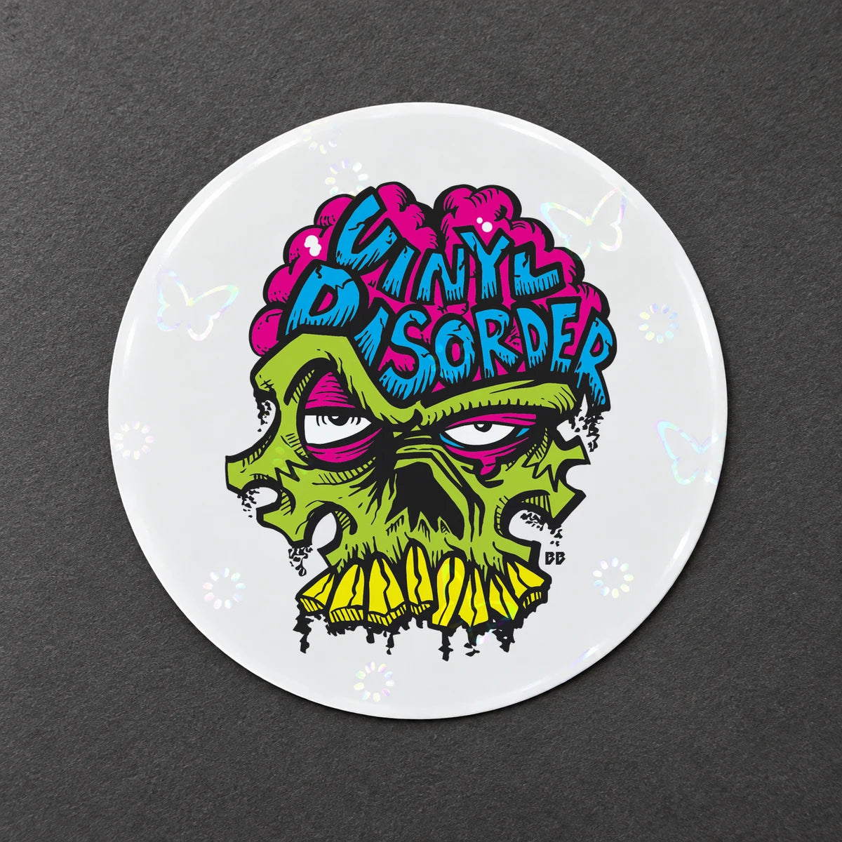 Reference-based render of the authentic Vinyl Disorder skull printed on Holographic Butterfly Overlay.