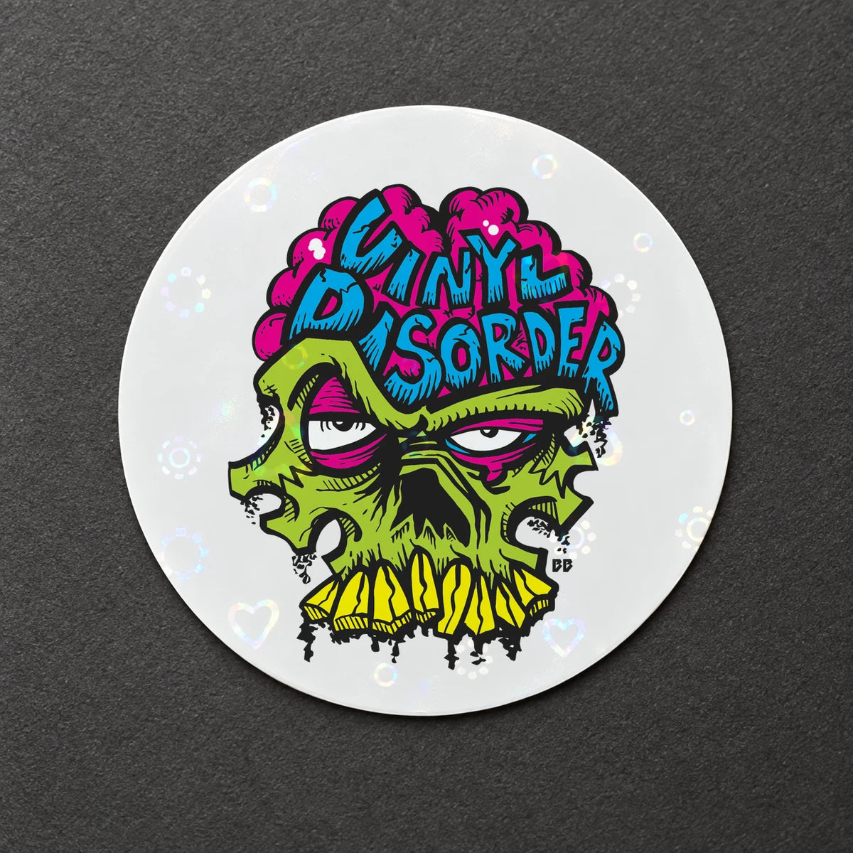 Reference-based render of the authentic Vinyl Disorder skull printed on Holographic Hearts Overlay.