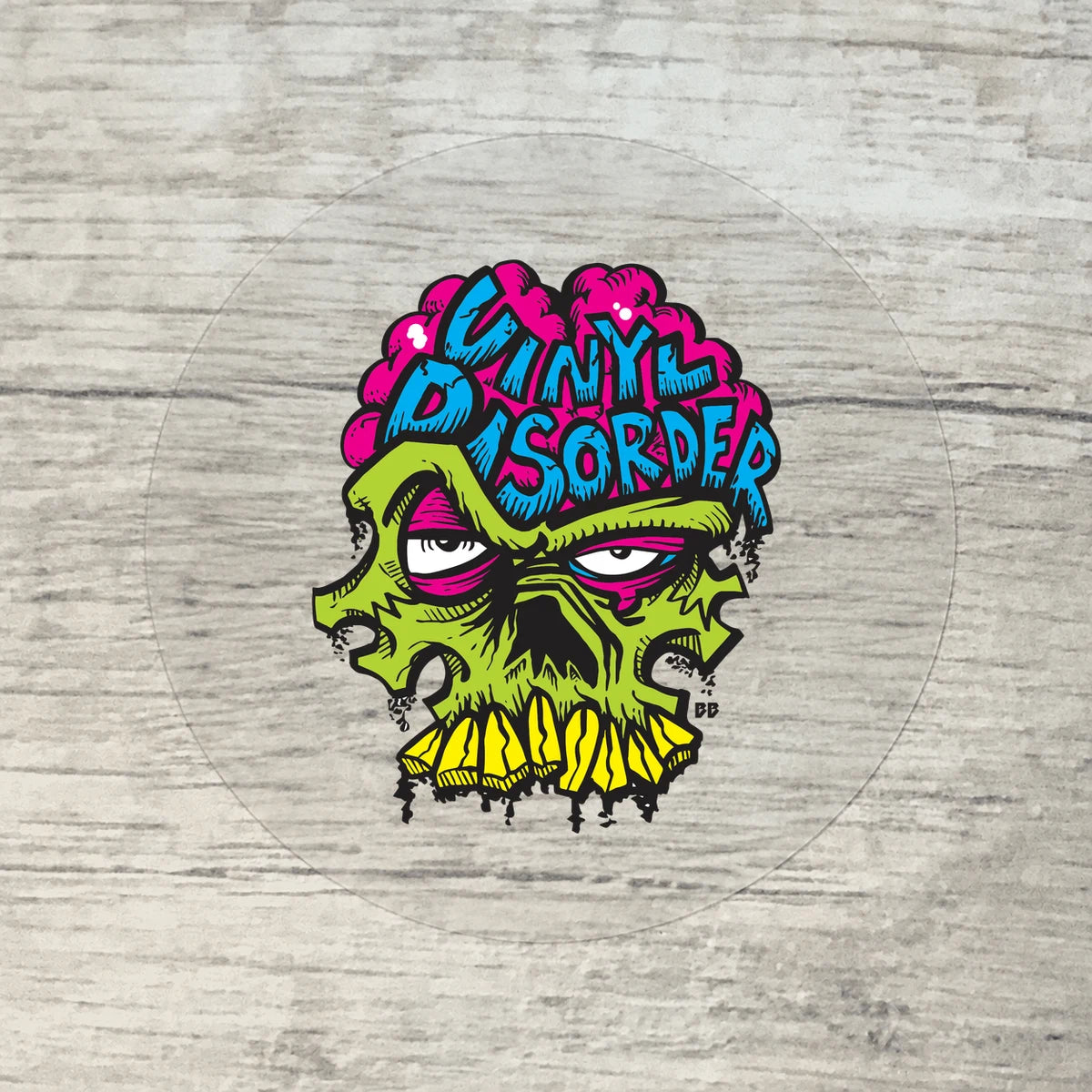 Clear circular vinyl sample on wood with opaque authentic Vinyl Disorder skull artwork.